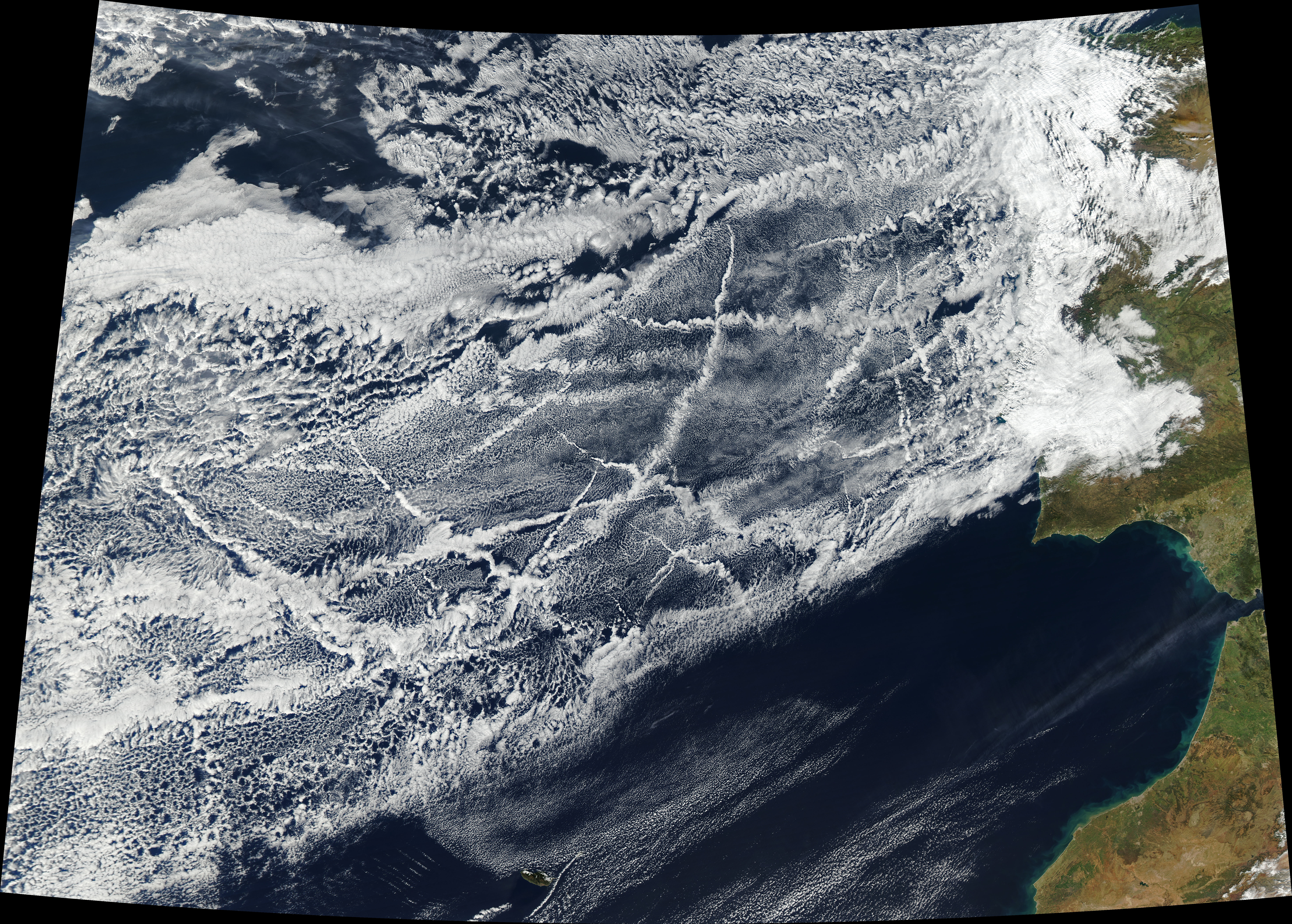 Satellite view of ship contrails (tracks) in the Atlantic Ocean showing white cloud streaks from ship exhaust aerosols